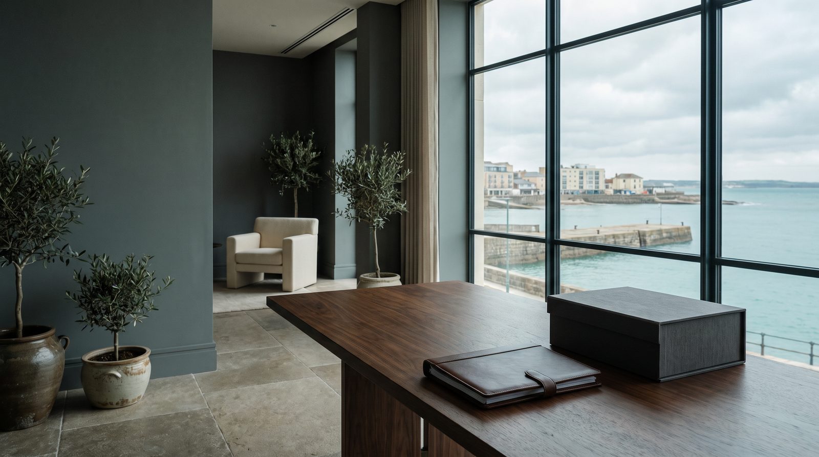 Discreet private advisory office overlooking a quiet coastline