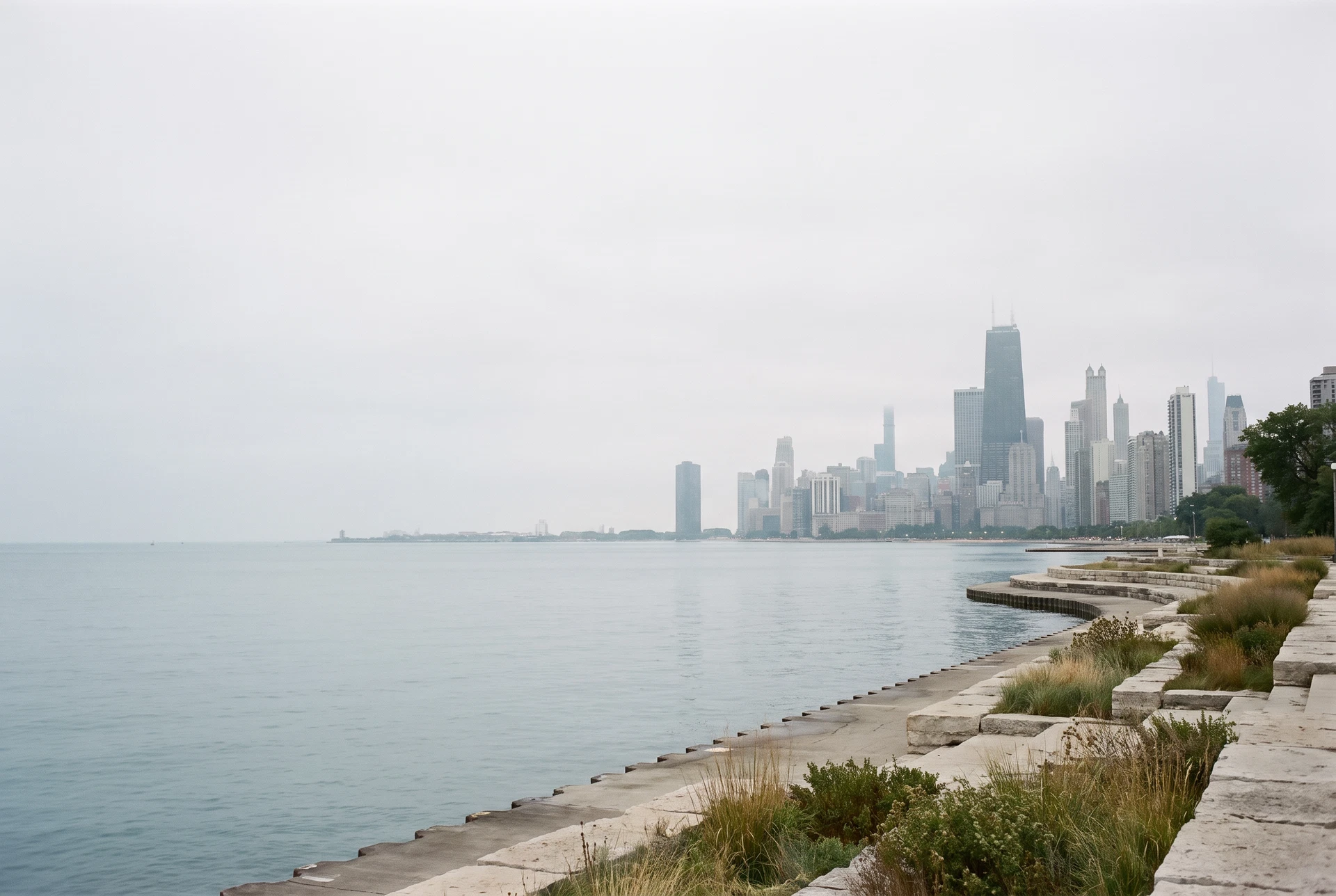 Chicago lakefront with calm Lake Michigan and a restrained city skyline